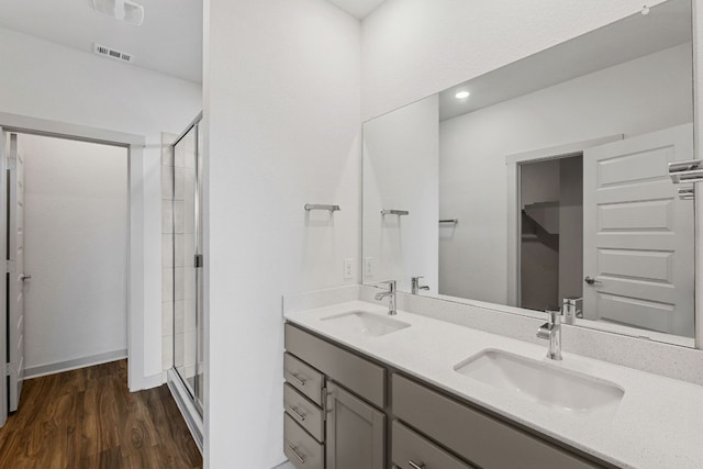 7514 Daves Landing Dr, Austin, TX 78724 - full bath featuring a stall shower, double vanity, and wood finished floors
