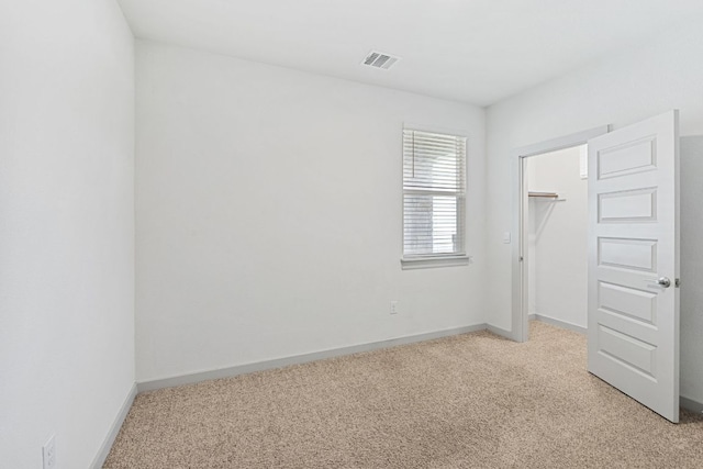 7514 Daves Landing Dr, Austin, TX 78724 - unfurnished bedroom featuring light colored carpet, a closet, and a spacious closet