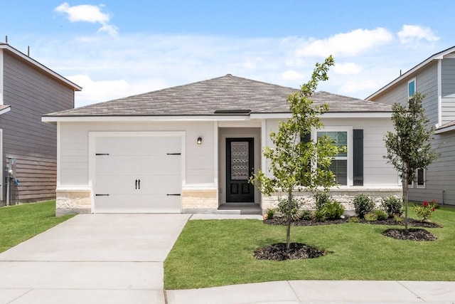 509 Aplite Pass, Maxwell, TX 78656 - ranch-style house featuring driveway, a front yard, a shingled roof, and an attached garage