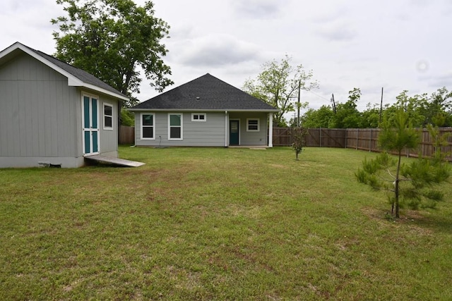 215 E 8th St, Elgin, TX 78621 - rear view of property with a fenced backyard and a shed