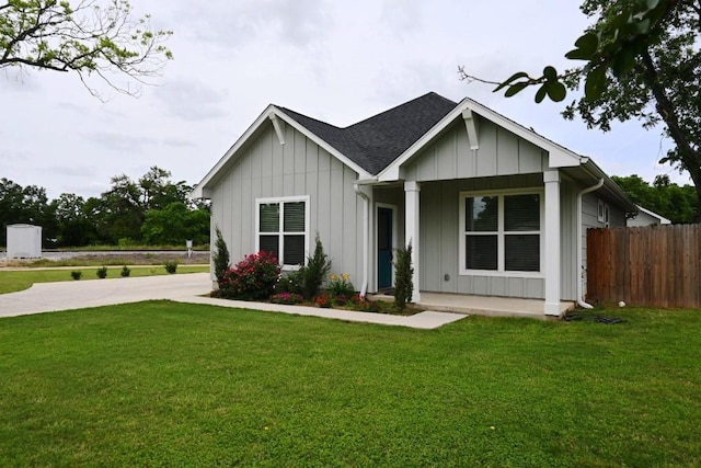 215 E 8th St, Elgin, TX 78621 - view of front of property with board and batten siding, roof with shingles, and a porch