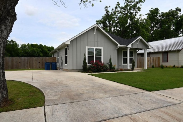 215 E 8th St, Elgin, TX 78621 - ranch-style home with board and batten siding and concrete driveway