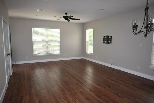 215 E 8th St, Elgin, TX 78621 - unfurnished room featuring ceiling fan, a chandelier, and dark wood-style flooring