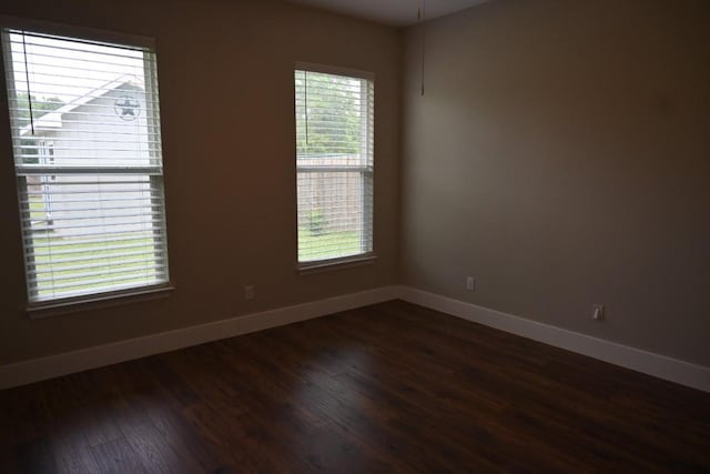 215 E 8th St, Elgin, TX 78621 - unfurnished room with baseboards and dark wood-style flooring