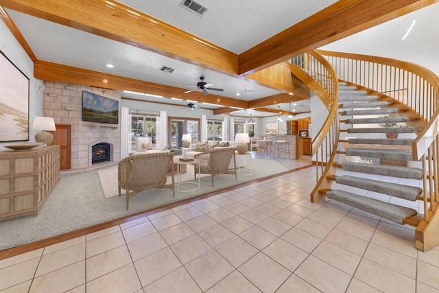 8300 Money Pit Rd, Killeen, TX 76542 - living room featuring tile patterned flooring, a fireplace, stairs, a ceiling fan, and beamed ceiling