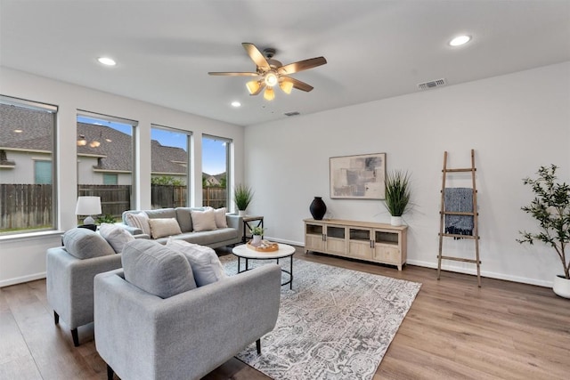 2437 Burberry Ln, Leander, TX 78641 - living room with wood finished floors, a ceiling fan, and recessed lighting