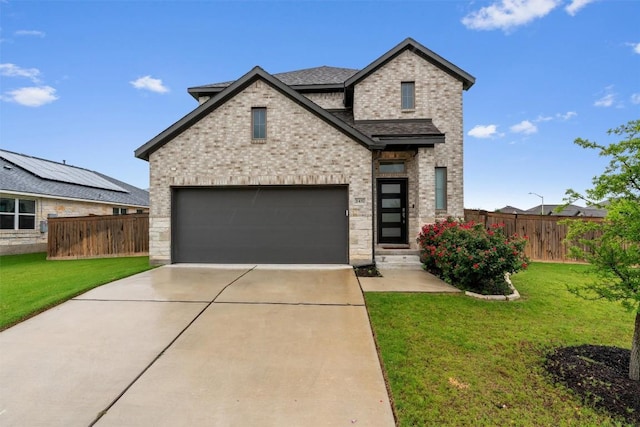 2437 Burberry Ln, Leander, TX 78641 - view of front of house with brick siding, driveway, a shingled roof, and a garage