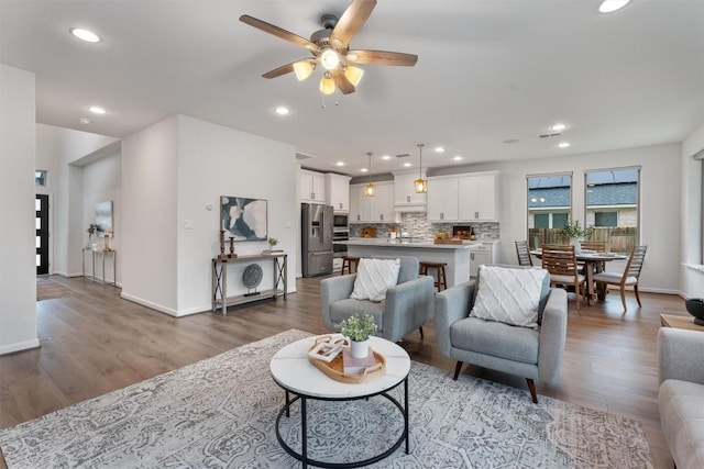 2437 Burberry Ln, Leander, TX 78641 - living room featuring ceiling fan, wood finished floors, and recessed lighting
