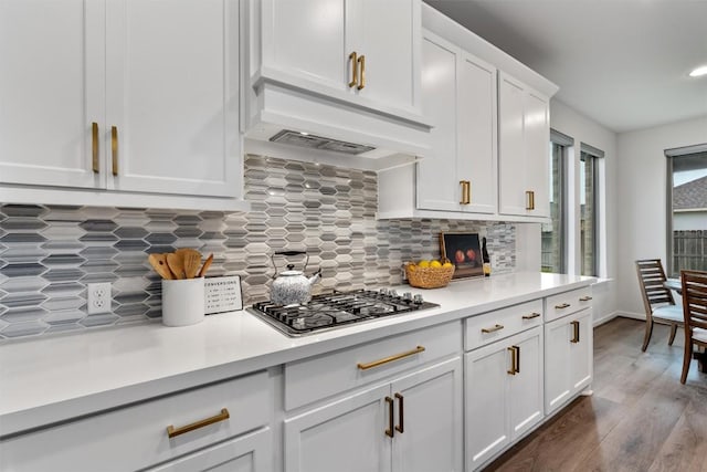 2437 Burberry Ln, Leander, TX 78641 - kitchen featuring stainless steel gas stovetop, light countertops, white cabinetry, decorative backsplash, and recessed lighting
