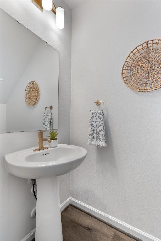2437 Burberry Ln, Leander, TX 78641 - bathroom featuring baseboards and wood finished floors