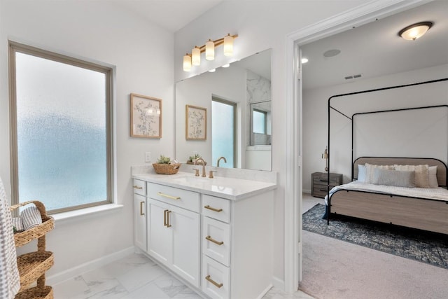 2437 Burberry Ln, Leander, TX 78641 - ensuite bathroom with vanity and marble look tile flooring