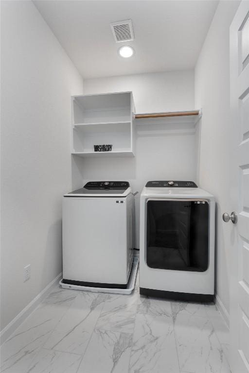 2437 Burberry Ln, Leander, TX 78641 - washroom with washing machine and dryer and light marble finish flooring