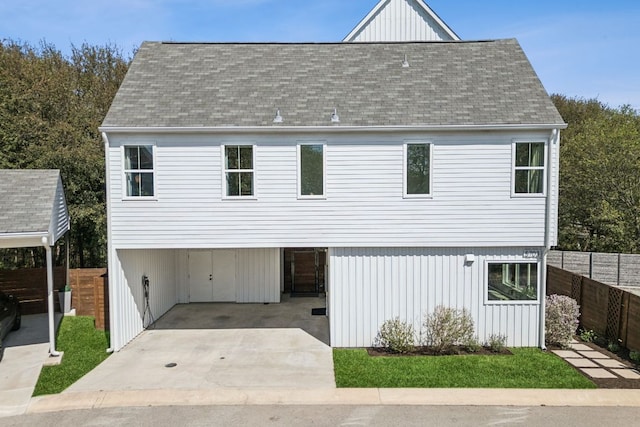 5703 Taunton Dr, Austin, TX 78723 - view of front of house featuring a carport, a shingled roof, driveway, and board and batten siding