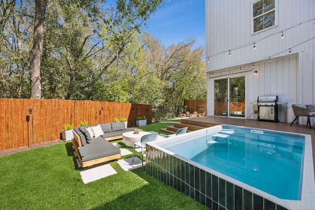 5703 Taunton Dr, Austin, TX 78723 - view of swimming pool with area for grilling, a wooden deck, an outdoor living space, and a fenced backyard