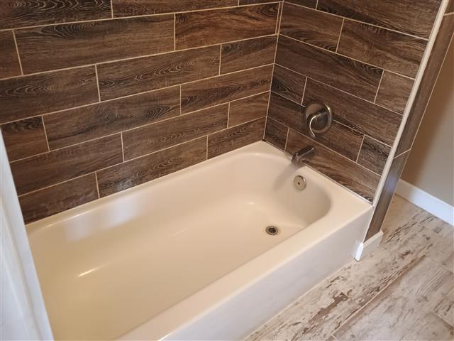 736 W Bell Ave, Rockdale, TX 76567 - full bathroom with baseboards
