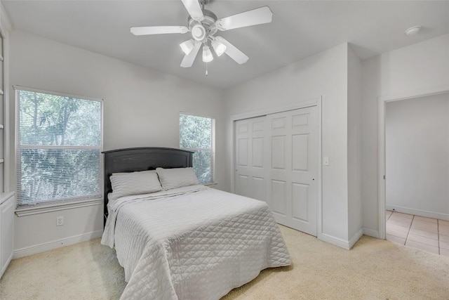 5511 Oakwood Cv Unit B, Austin, TX 78731 - bedroom with multiple windows, light carpet, a closet, and a ceiling fan