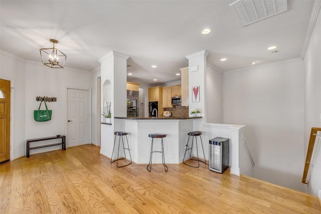 5511 Oakwood Cv Unit B, Austin, TX 78731 - kitchen with stainless steel microwave, built in refrigerator, light brown cabinetry, tasteful backsplash, and light wood-style floors