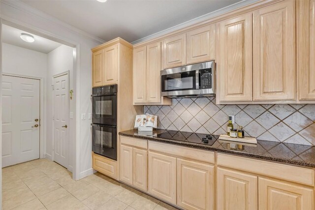 5511 Oakwood Cv Unit B, Austin, TX 78731 - kitchen featuring black appliances, light tile patterned floors, light brown cabinetry, tasteful backsplash, and dark stone counters