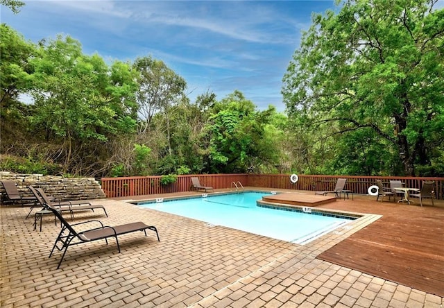 5511 Oakwood Cv Unit B, Austin, TX 78731 - community pool with a deck, view of wooded area, and a patio