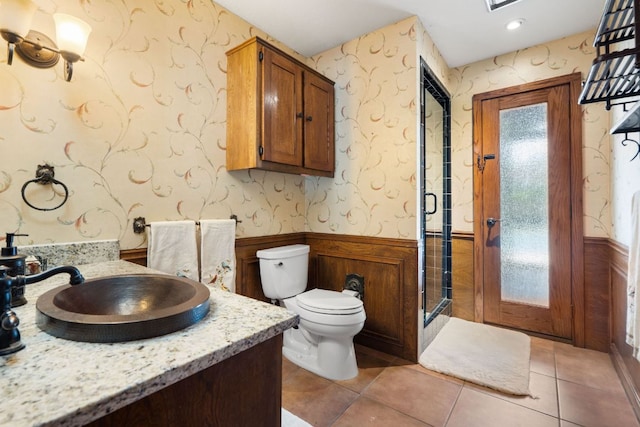11923 Brookwood Cir, Austin, TX 78750 - bathroom with a wainscoted wall, a stall shower, wallpapered walls, vanity, and tile patterned flooring