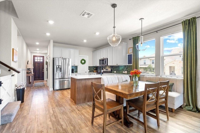 496 Sawtooth Mountain Way, Dripping Springs, TX 78620 - kitchen with appliances with stainless steel finishes, light wood finished floors, light countertops, recessed lighting, and tasteful backsplash