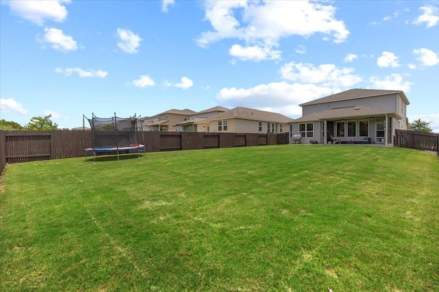 496 Sawtooth Mountain Way, Dripping Springs, TX 78620 - fenced backyard with a trampoline