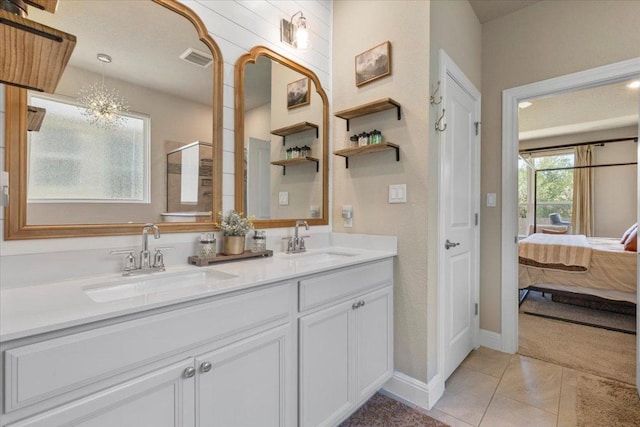 496 Sawtooth Mountain Way, Dripping Springs, TX 78620 - full bathroom with double vanity, ensuite bathroom, tile patterned floors, and a shower