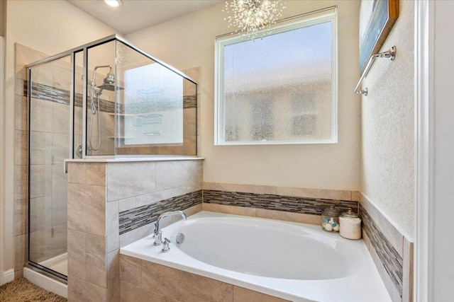 496 Sawtooth Mountain Way, Dripping Springs, TX 78620 - bathroom featuring a garden tub, a shower stall, and a chandelier