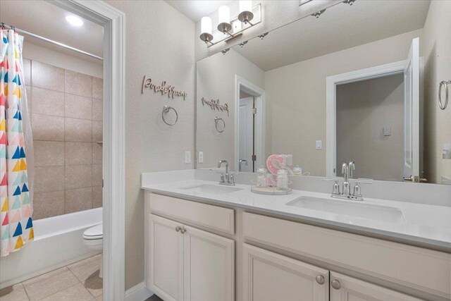 496 Sawtooth Mountain Way, Dripping Springs, TX 78620 - bathroom with double vanity, tile patterned flooring, and shower / tub combo with curtain
