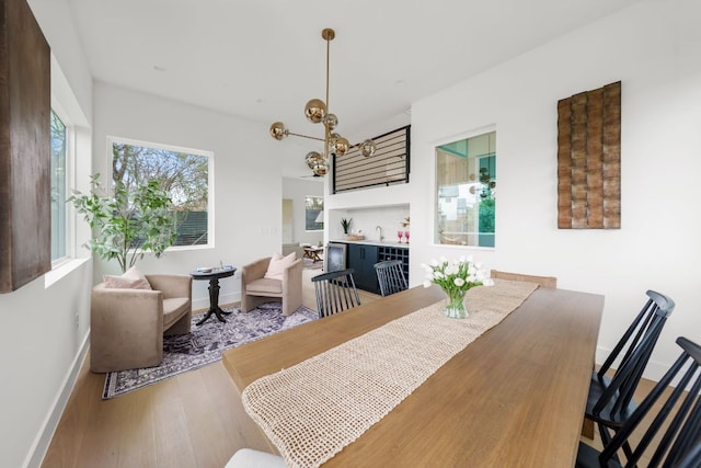 1703 Miami Dr, Austin, TX 78733 - dining space featuring healthy amount of natural light, wood finished floors, and a chandelier