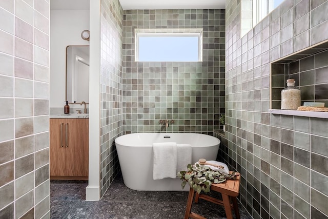 1703 Miami Dr, Austin, TX 78733 - bathroom featuring tile walls, a freestanding bath, and vanity