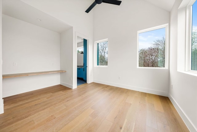 1703 Miami Dr, Austin, TX 78733 - empty room featuring light wood-type flooring, ceiling fan, and vaulted ceiling