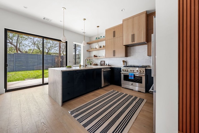 1703 Miami Dr, Austin, TX 78733 - kitchen featuring stainless steel appliances, open shelves, light countertops, backsplash, and light wood-type flooring