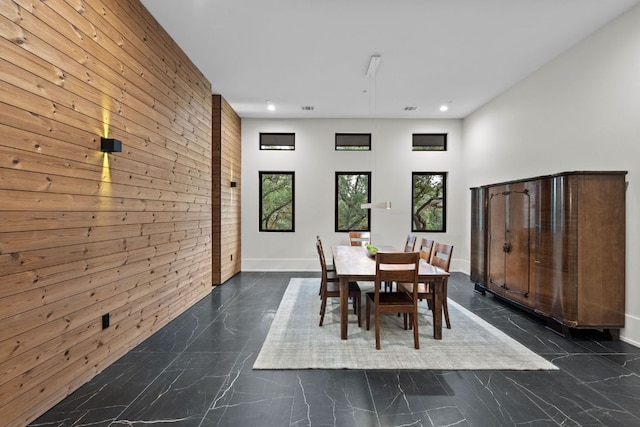 4904 Old Bee Caves Rd, Austin, TX 78746 - dining space featuring wooden walls, dark marble finish flooring, recessed lighting, and an accent wall