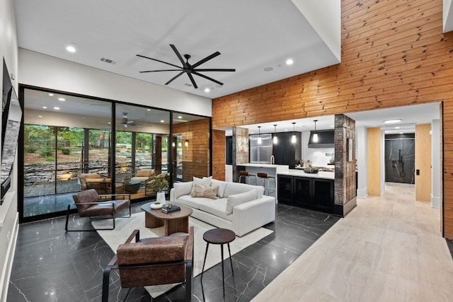 4904 Old Bee Caves Rd, Austin, TX 78746 - living room featuring ceiling fan, dark marble finish floors, wooden walls, and recessed lighting