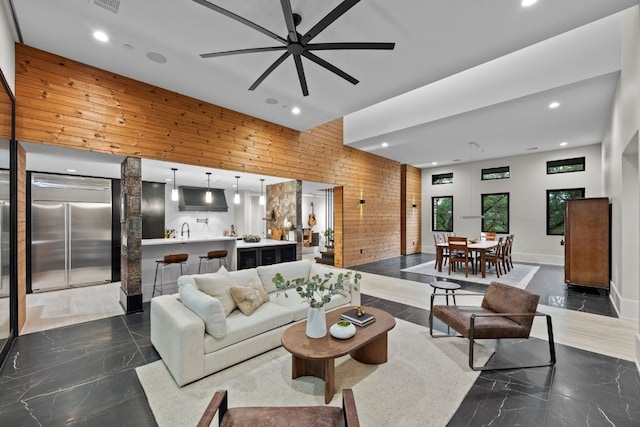 4904 Old Bee Caves Rd, Austin, TX 78746 - living area featuring recessed lighting, wooden walls, dark marble finish flooring, and a ceiling fan
