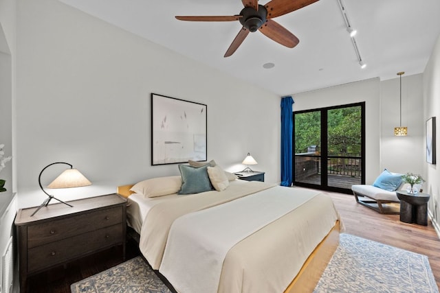 4904 Old Bee Caves Rd, Austin, TX 78746 - bedroom with rail lighting, access to outside, wood finished floors, and a ceiling fan