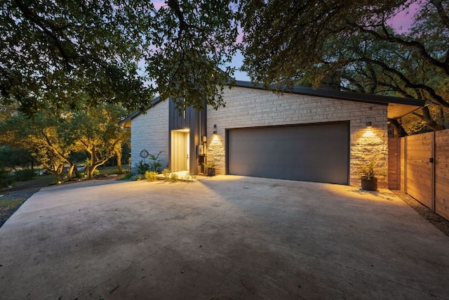 4904 Old Bee Caves Rd, Austin, TX 78746 - view of front facade with stone siding, driveway, and an attached garage