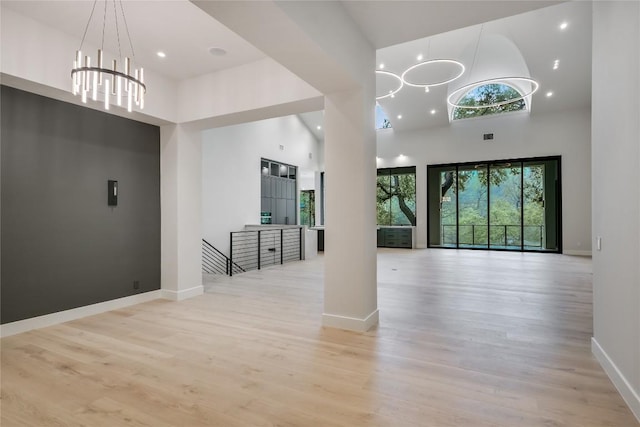 5217 S Scout Island Cir, Austin, TX 78731 - foyer with a chandelier, a towering ceiling, wood finished floors, and recessed lighting