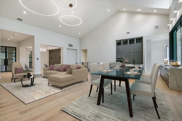 5217 S Scout Island Cir, Austin, TX 78731 - dining space with high vaulted ceiling, light wood-style flooring, and recessed lighting