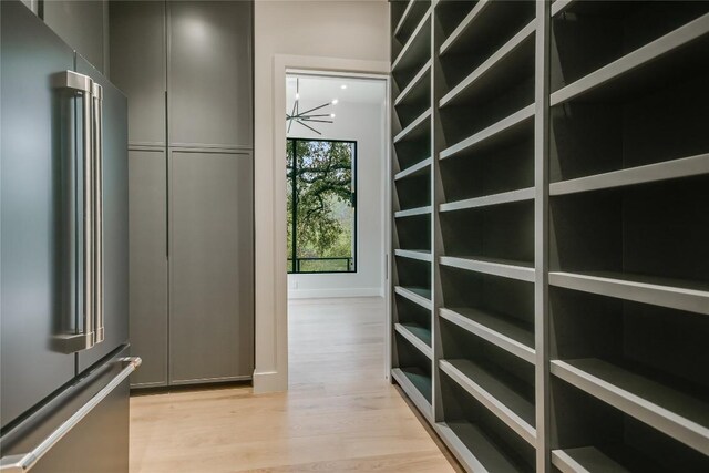 5217 S Scout Island Cir, Austin, TX 78731 - spacious closet featuring light wood-type flooring and a chandelier