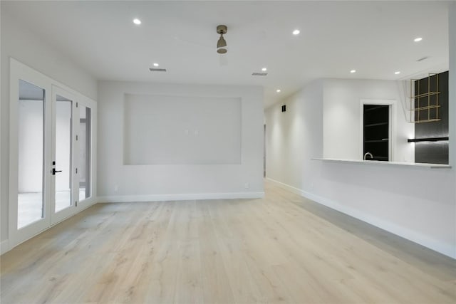 5217 S Scout Island Cir, Austin, TX 78731 - unfurnished living room with french doors, light wood-style floors, and recessed lighting