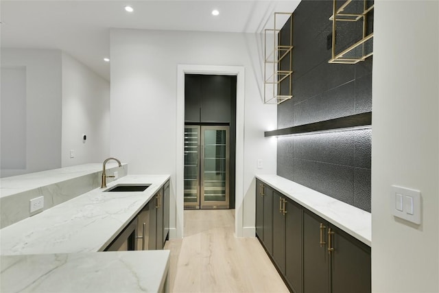 5217 S Scout Island Cir, Austin, TX 78731 - kitchen featuring light wood-type flooring, light stone counters, recessed lighting, open shelves, and beverage cooler