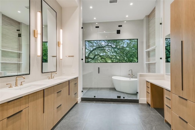 5217 S Scout Island Cir, Austin, TX 78731 - full bathroom with a freestanding bath, double vanity, tile patterned flooring, a shower stall, and recessed lighting