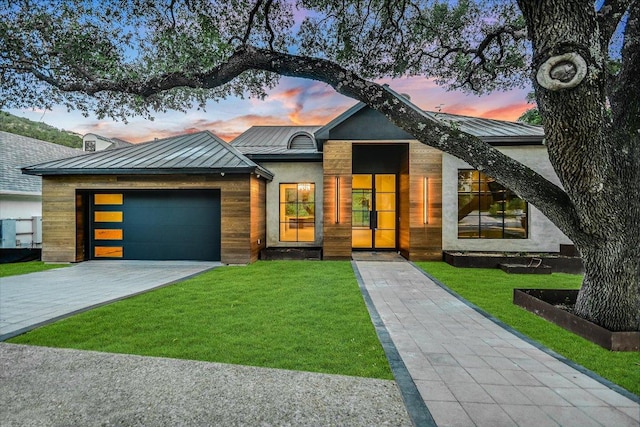 5217 S Scout Island Cir, Austin, TX 78731 - contemporary home featuring a standing seam roof, a metal roof, a lawn, and a garage
