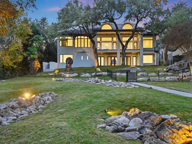5217 S Scout Island Cir, Austin, TX 78731 - rear view of property featuring an outdoor fire pit, stucco siding, and stairway