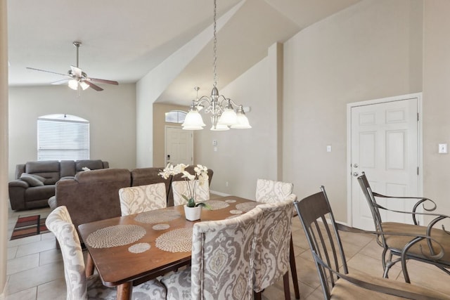 7233 Menchaca Rd Unit 22, Austin, TX 78745 - dining area featuring light tile patterned floors, vaulted ceiling, a ceiling fan, and a chandelier