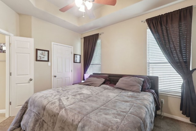 7233 Menchaca Rd Unit 22, Austin, TX 78745 - carpeted bedroom featuring a tray ceiling and ceiling fan