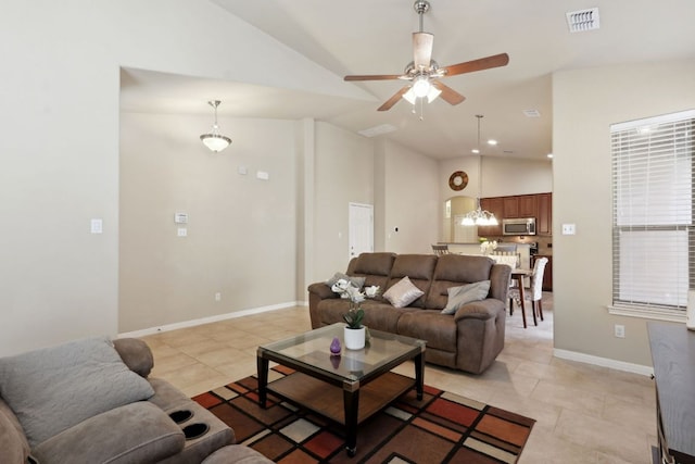 7233 Menchaca Rd Unit 22, Austin, TX 78745 - living area with ceiling fan, light tile patterned floors, a chandelier, and high vaulted ceiling