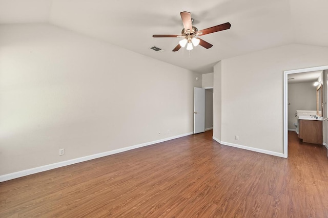 14512 Hartsmith Dr, Austin, TX 78725 - unfurnished bedroom with vaulted ceiling, wood finished floors, a ceiling fan, and ensuite bath